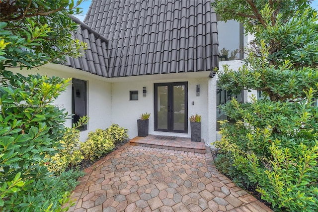 view of exterior entry featuring french doors