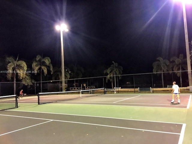 view of tennis court with fence