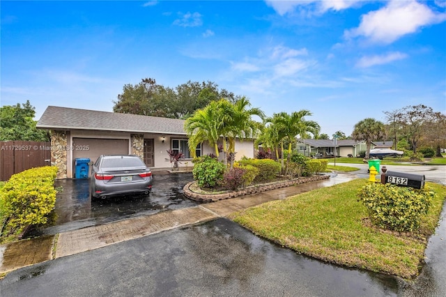 ranch-style home with a front lawn and a garage