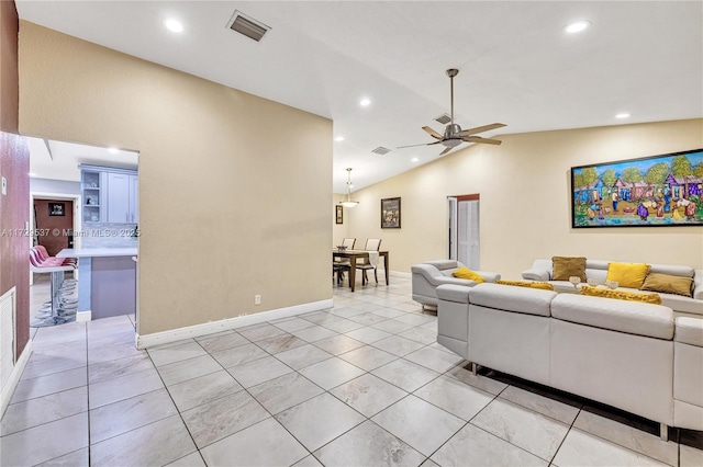 tiled living room featuring lofted ceiling and ceiling fan