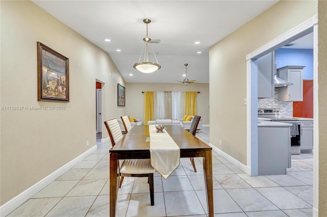 dining area featuring light tile patterned floors and vaulted ceiling