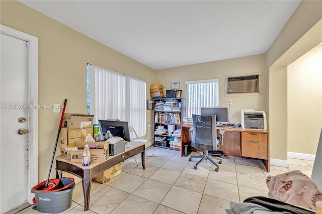 office area with a wall unit AC and light tile patterned floors