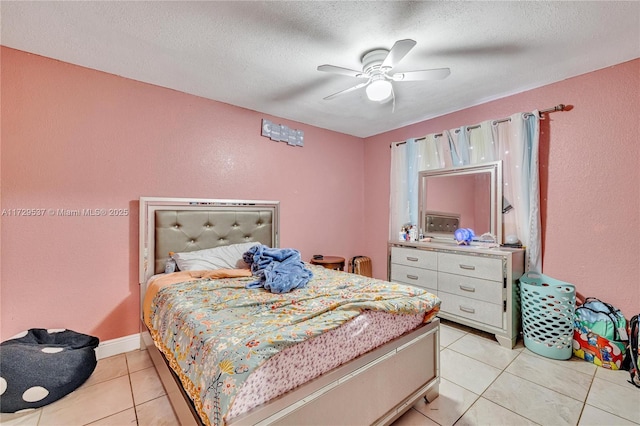 bedroom with ceiling fan, a textured ceiling, and light tile patterned floors