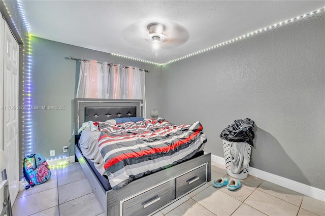 tiled bedroom featuring ceiling fan