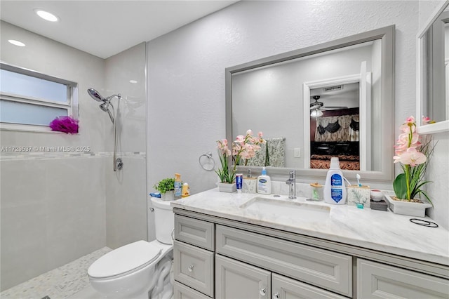 bathroom with toilet, walk in shower, and vanity