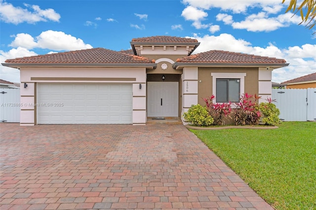 mediterranean / spanish-style house featuring a garage and a front yard