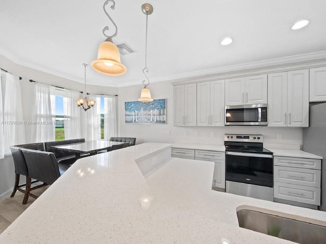 kitchen with light stone counters, decorative light fixtures, appliances with stainless steel finishes, and crown molding