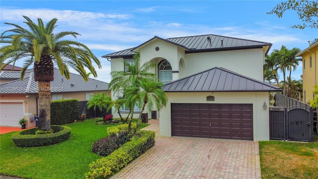 view of front of house featuring a garage and a front lawn