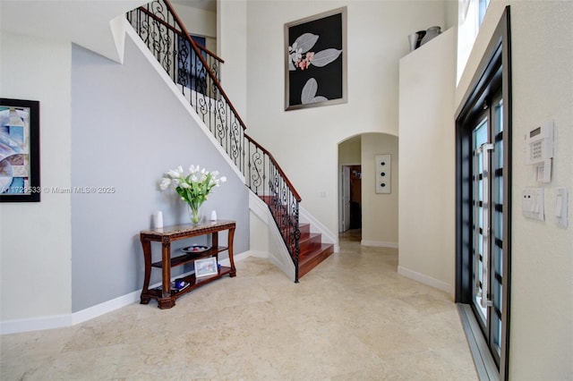 entryway featuring a towering ceiling