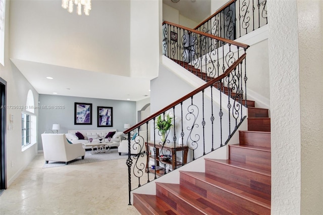 stairs featuring a towering ceiling