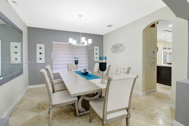 dining space with a chandelier