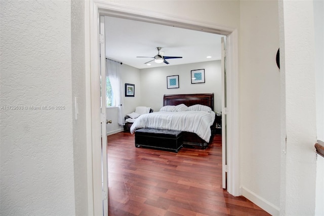 bedroom featuring ceiling fan and dark hardwood / wood-style floors