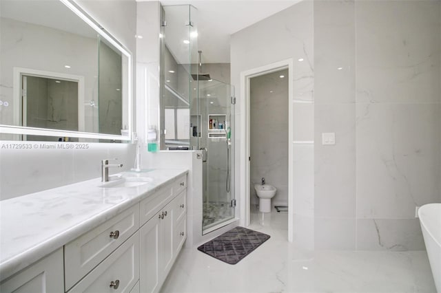 bathroom with vanity, a bidet, tile walls, and a shower with shower door