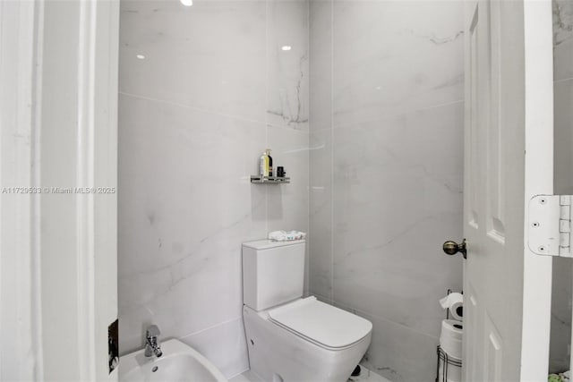 bathroom with a bidet and toilet