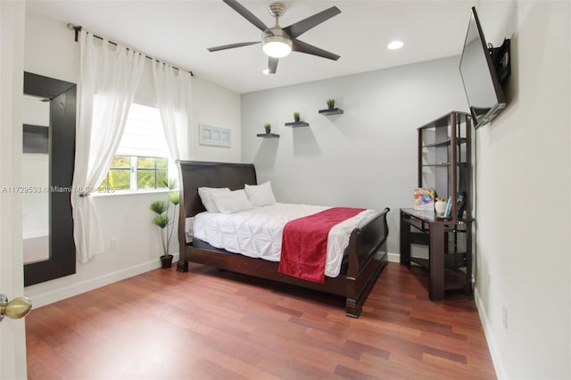 bedroom featuring ceiling fan and dark hardwood / wood-style flooring