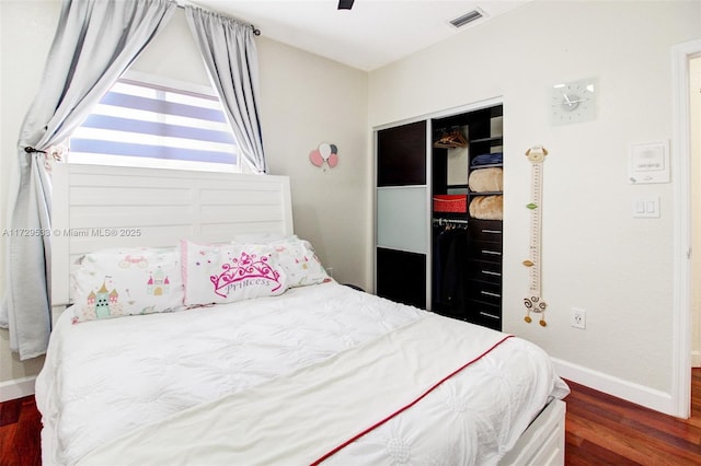 bedroom featuring a closet, ceiling fan, and dark wood-type flooring