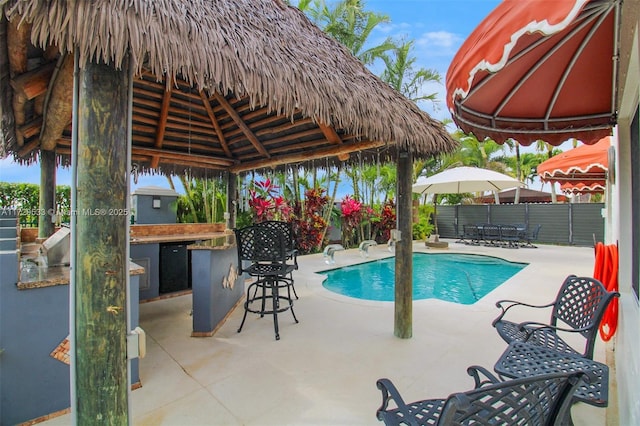 view of pool featuring a gazebo, an outdoor bar, and a patio