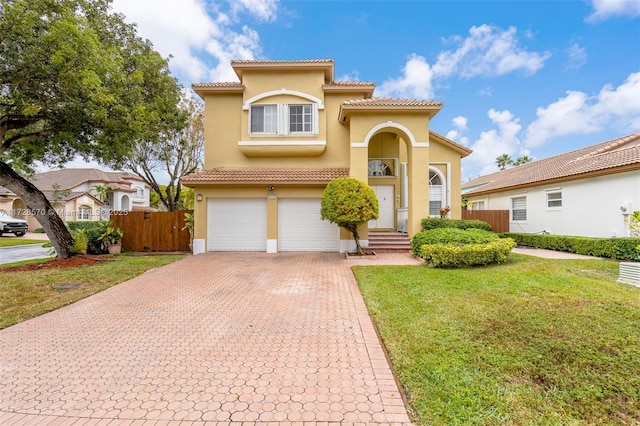 mediterranean / spanish house with a garage and a front yard