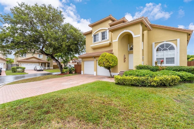 mediterranean / spanish house with a garage and a front lawn