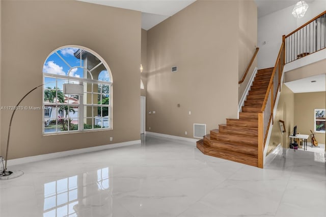 foyer entrance featuring a towering ceiling