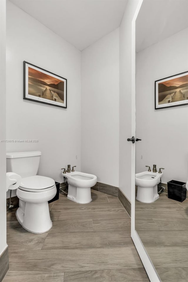 bathroom with a bidet and toilet