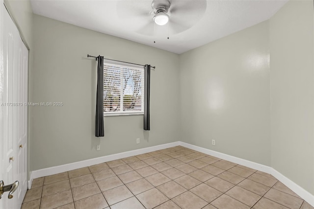 tiled spare room featuring ceiling fan