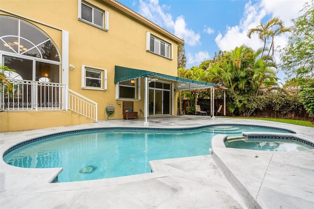 view of pool featuring an in ground hot tub and a patio area