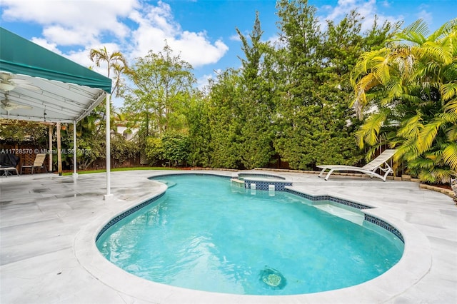 view of swimming pool with an in ground hot tub and a patio