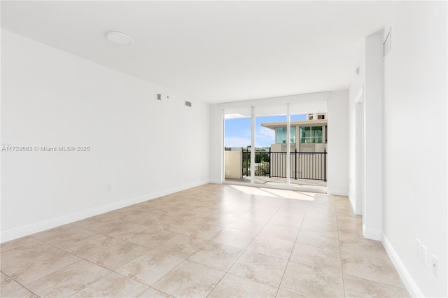 spare room with light tile patterned floors