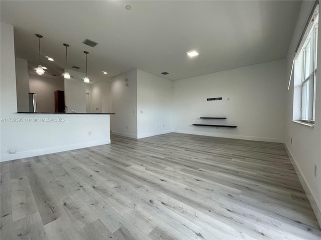 unfurnished living room with light wood-type flooring