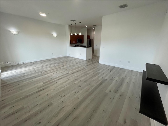 unfurnished living room featuring light wood-type flooring