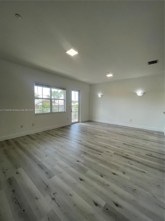 empty room with light hardwood / wood-style flooring