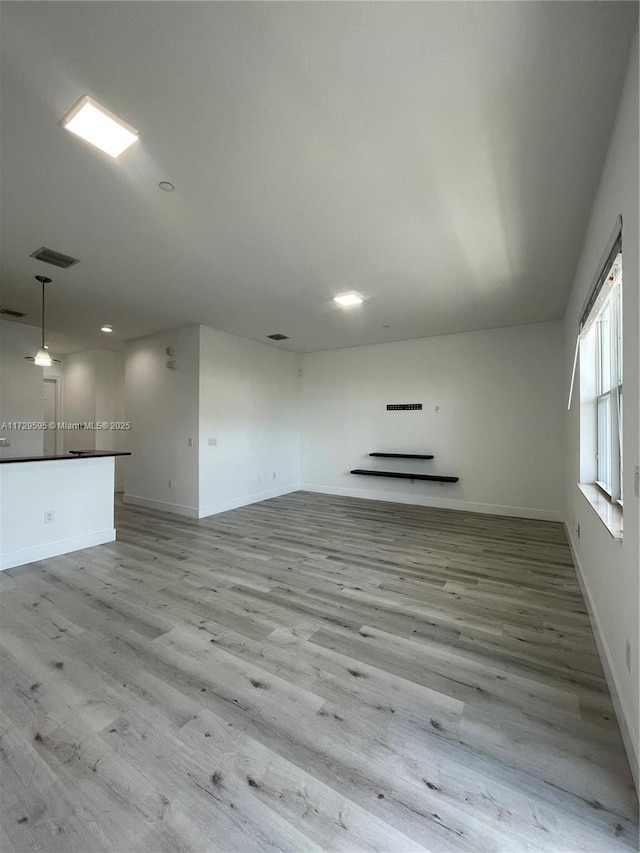 unfurnished living room with light hardwood / wood-style flooring