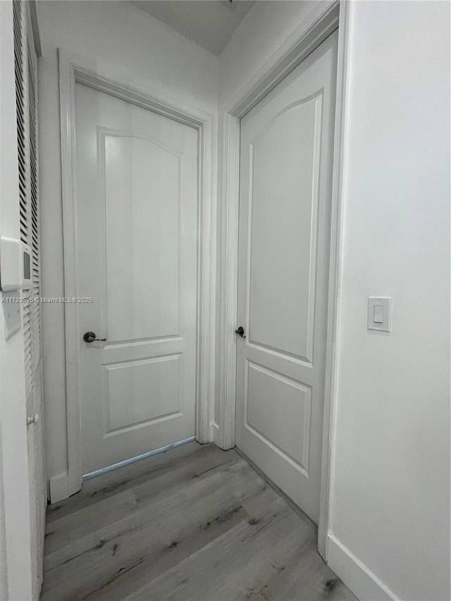 hallway with light hardwood / wood-style flooring