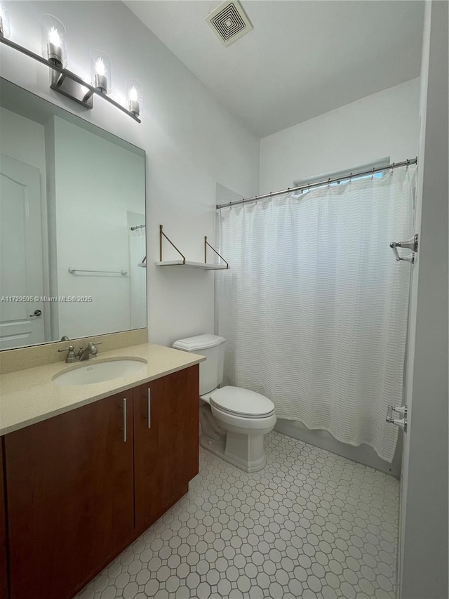 full bathroom featuring toilet, vanity, and shower / bath combination with curtain