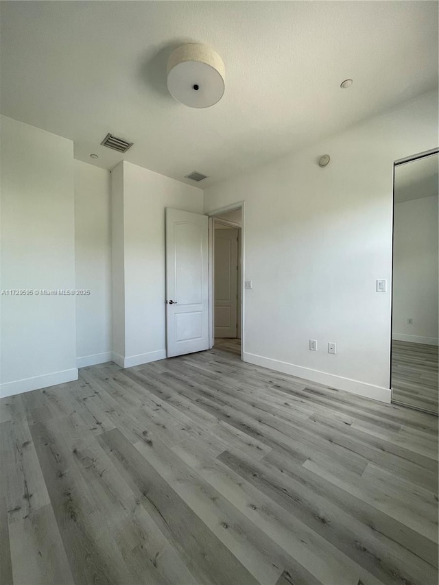 unfurnished bedroom with light wood-type flooring