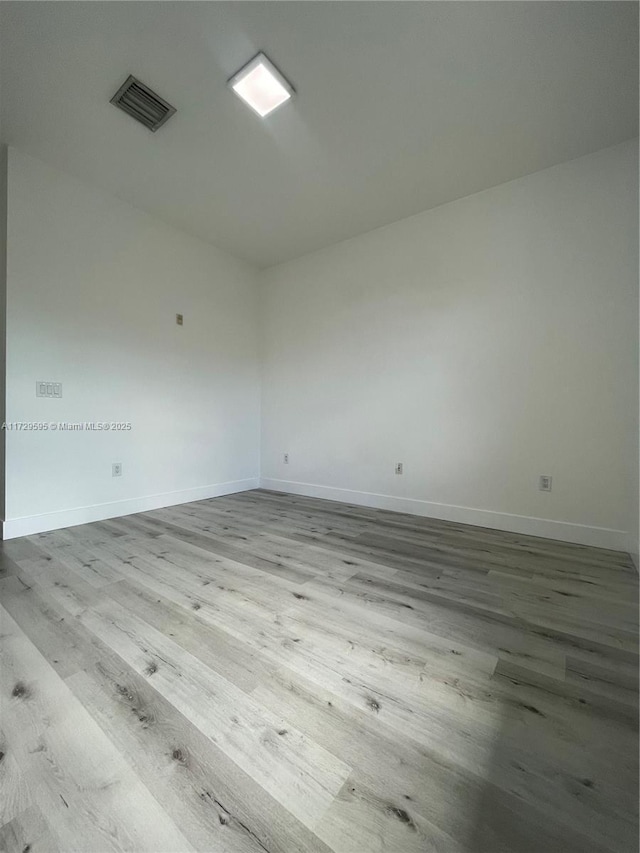 spare room with wood-type flooring