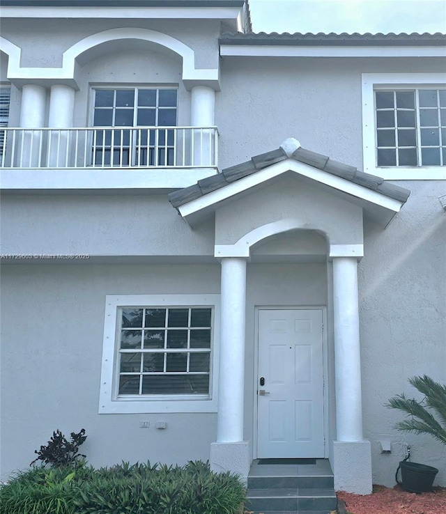 entrance to property with a balcony