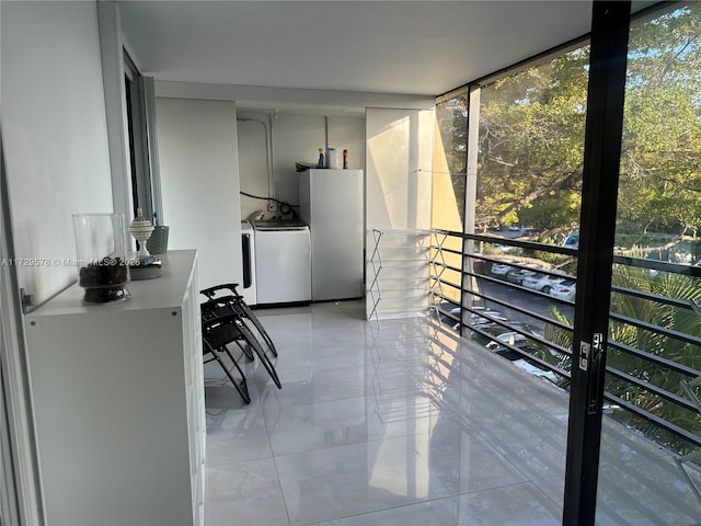 sunroom featuring washer and clothes dryer