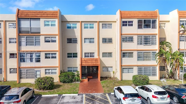 view of building exterior with uncovered parking