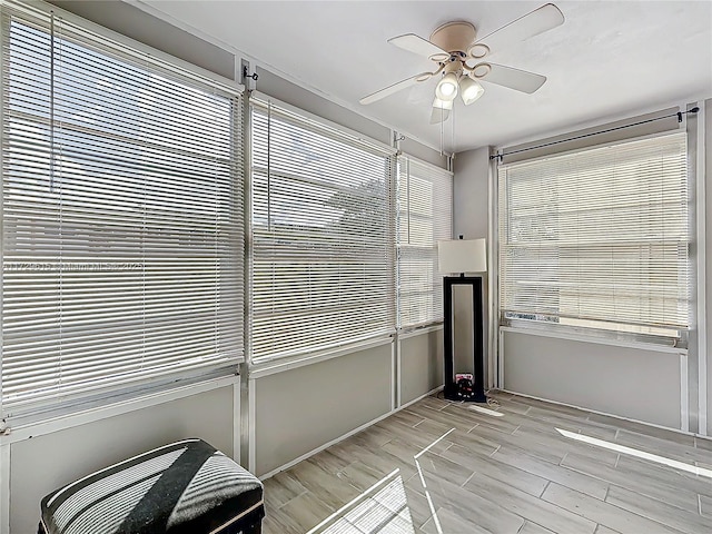 interior space with ceiling fan