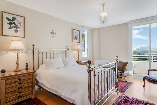 bedroom featuring floor to ceiling windows, wood-type flooring, and multiple windows