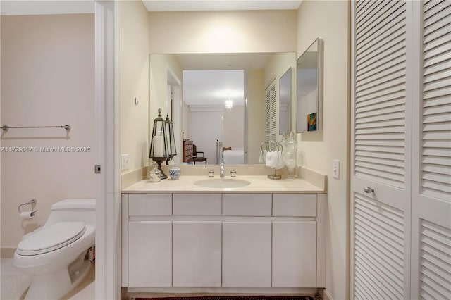 bathroom featuring toilet and vanity