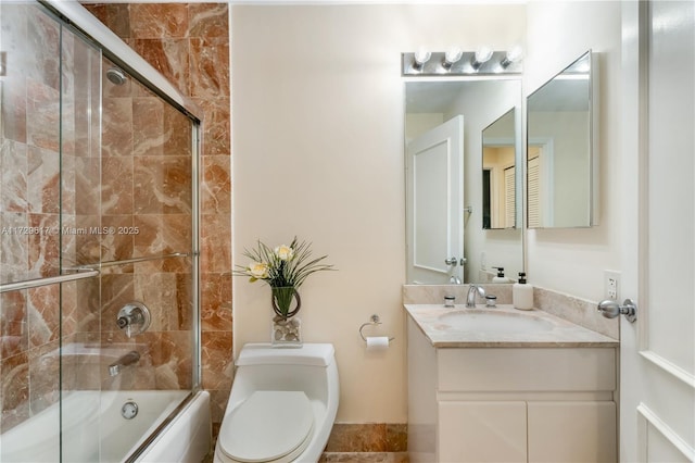 full bathroom with combined bath / shower with glass door, vanity, and toilet