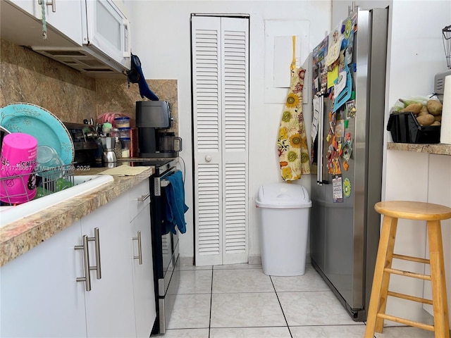 laundry room with light tile patterned flooring