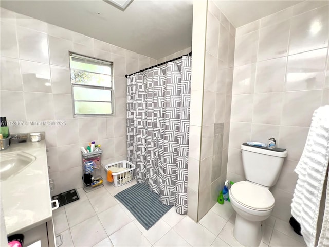 bathroom with tile patterned flooring, vanity, a shower with curtain, tile walls, and toilet