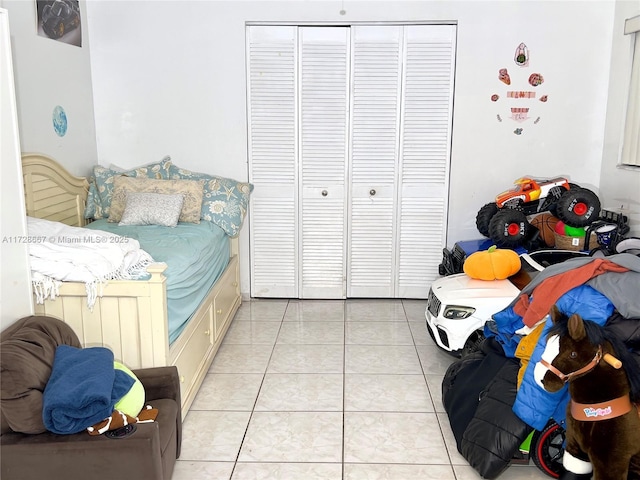 tiled bedroom with a closet