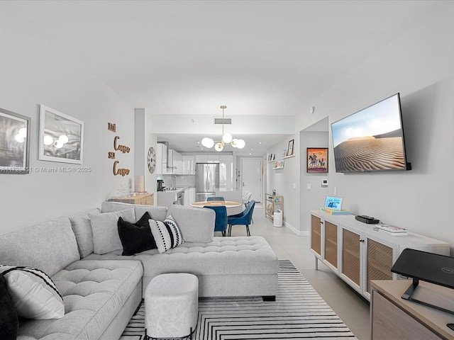 living room featuring a chandelier and light tile patterned flooring