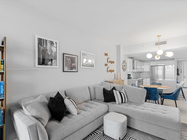 living room with sink and a chandelier