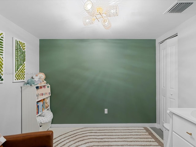 bedroom with a closet and an inviting chandelier